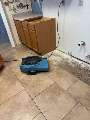 Air mover drying a kitchen