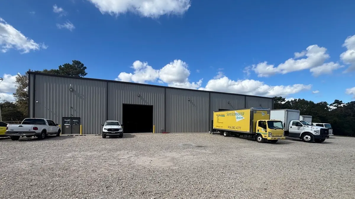 Company building with yellow work trucks