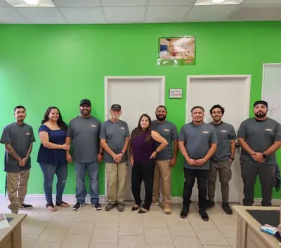 Team photo in the green-walled office