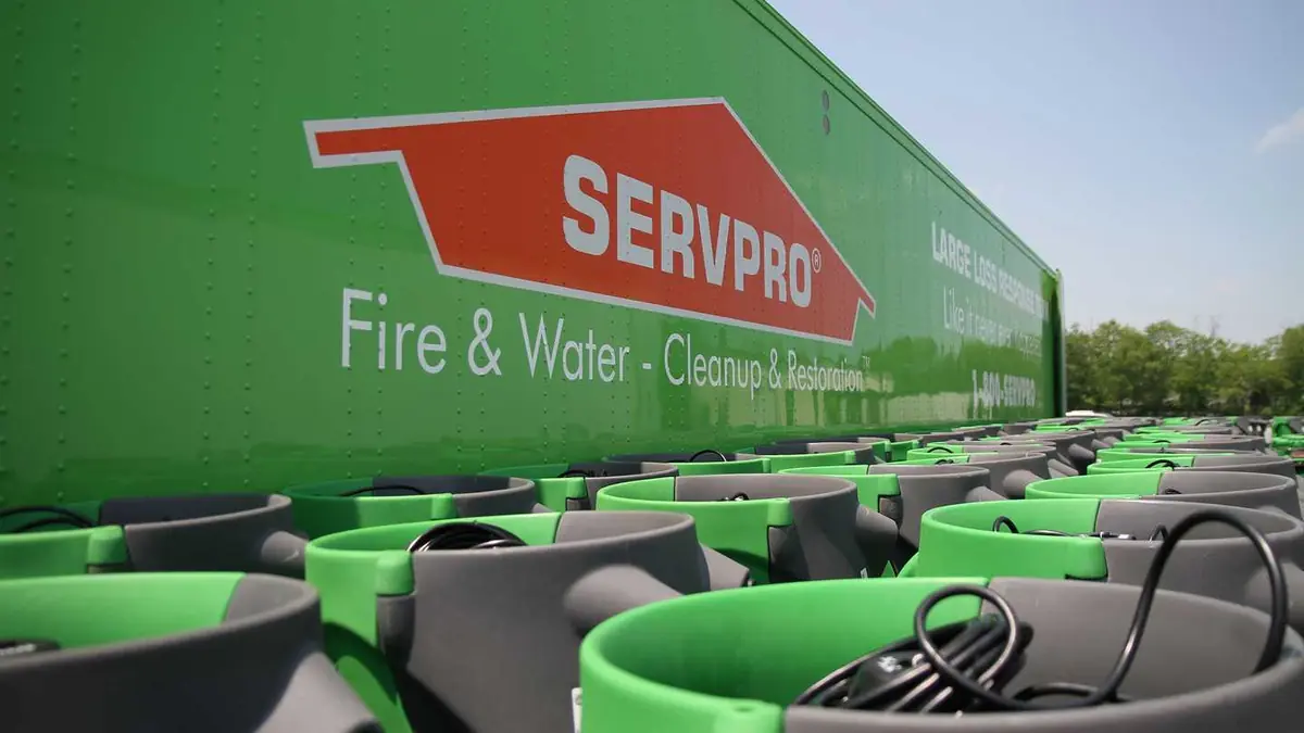 Green SERVPRO truck with air movers