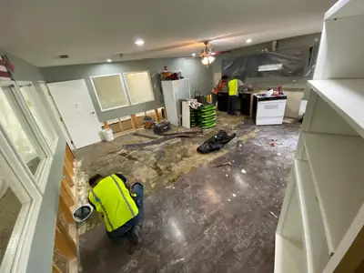 Technician removing damaged flooring