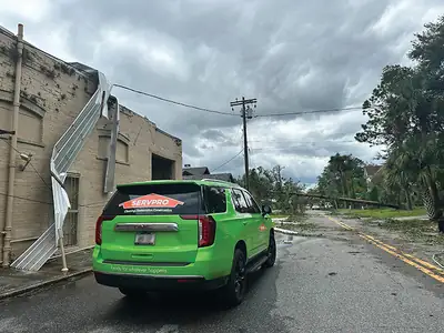 Green SERVPRO vehicle on a street