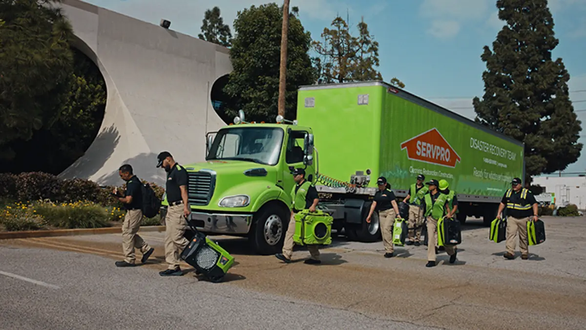 SERVPRO crew and green work truck at a job