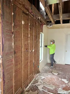 Technician removing a damaged wall