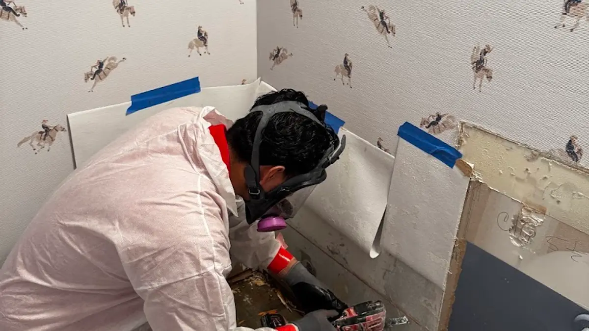 Technician working on a damaged wall