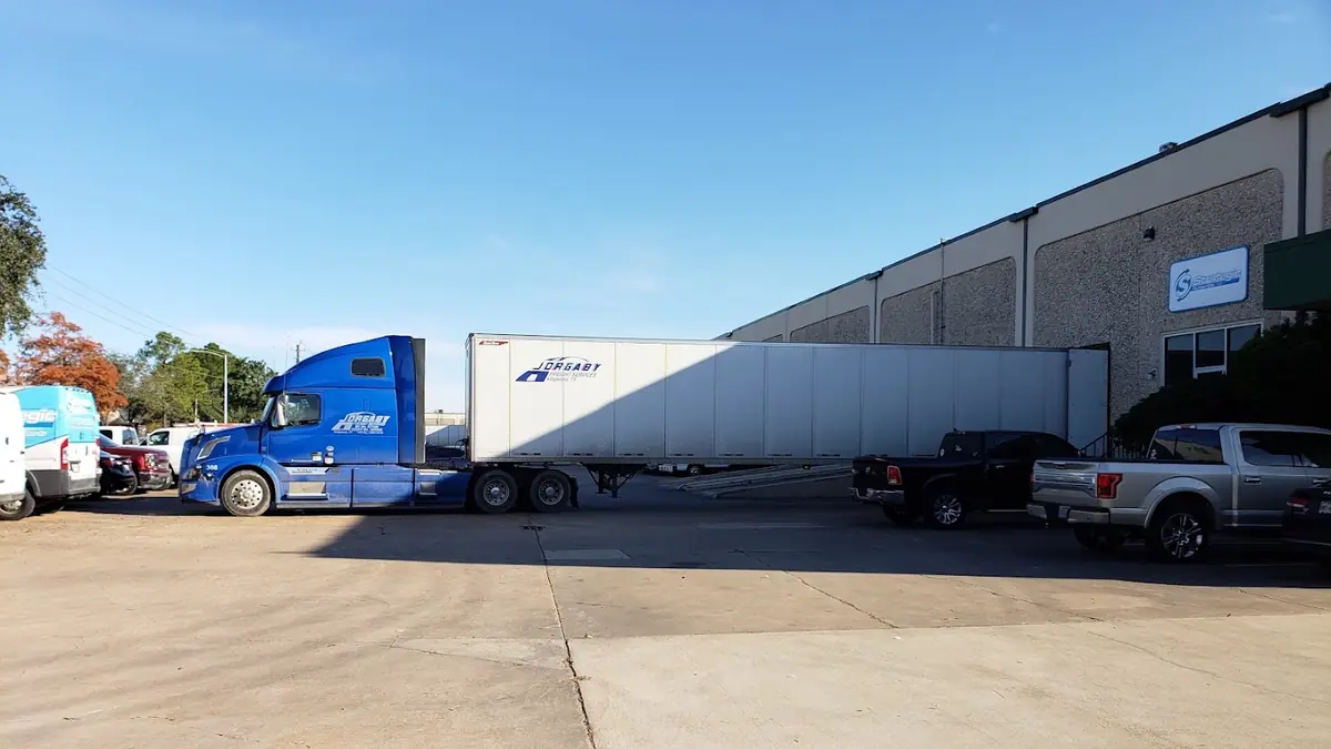 Company vehicles parked at a warehouse yard