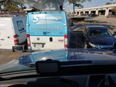 Branded service van in a parking lot