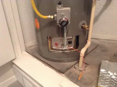 Water heater base inspected for leaks