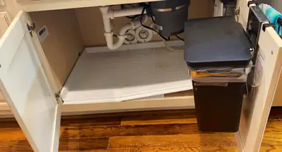 Cabinet base removed to expose damage