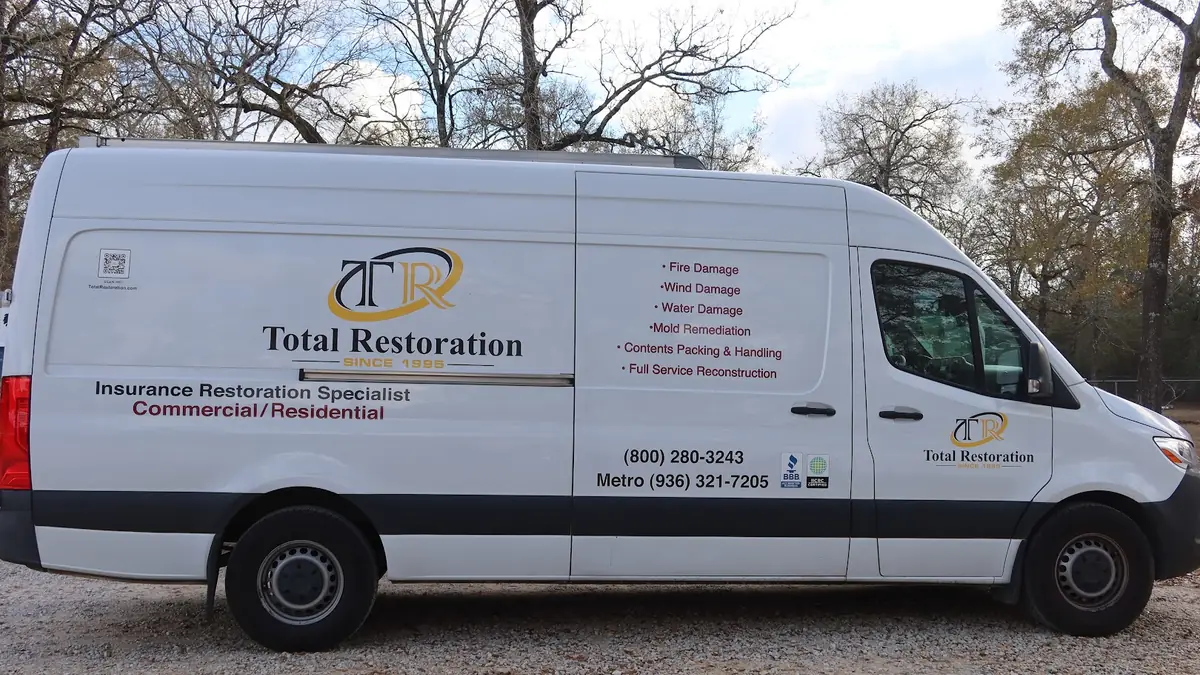 Total Restoration branded van outside a home