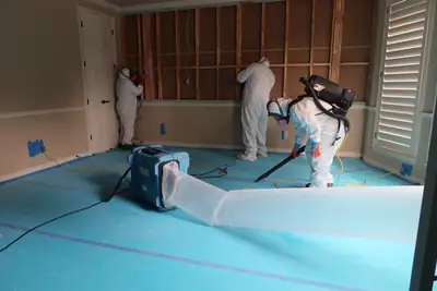 Technicians in protective suits inside containment