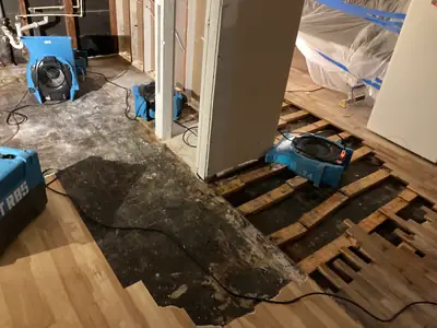 Damaged flooring removed with a dehumidifier running