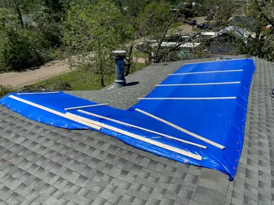 Tarp covering a damaged roof