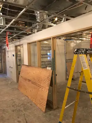 Gutted office space with a ladder