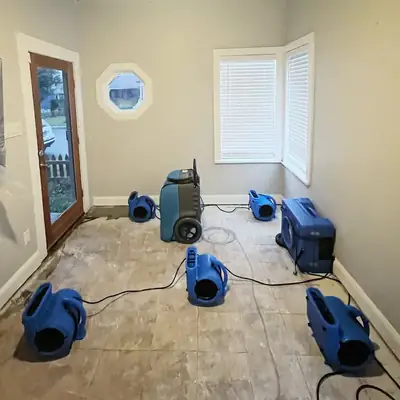 Air movers drying a room
