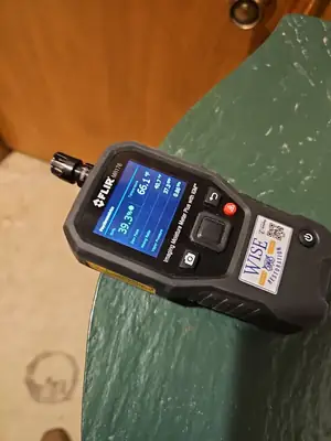 Moisture meter against a wall