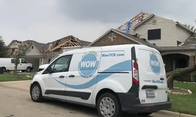 WOW Total Cleaning & Restoration branded van in a neighbourhood